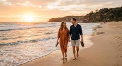 Couple walking along an Australian beach at sunset representing casual dating in Australia